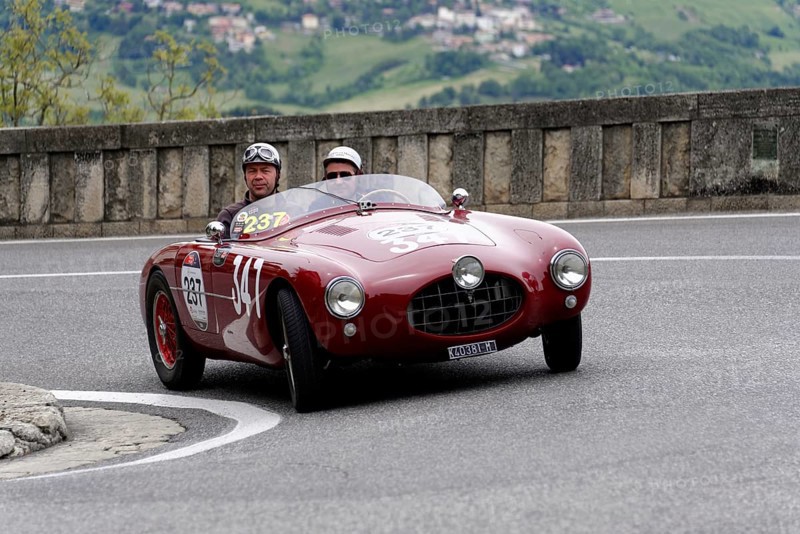 No. 237, Ermini 1100 Sport Motto, built in 1952, red vintage car with helmet-wearing occupants on a winding road, Mille Miglia 2014 or 1000 Miglia, vintage car race, San Marino, Italy