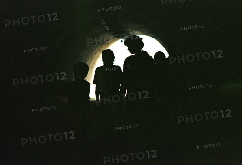 BIH, Sarajevo, 01.09.1995 -- Passers-by walk through an underpass in Sarajevo. During the war years, this underpass served as a bunker for people and artillery. -- Citizens crossing a tunnel, that connects two parts of the city Sarajevo. The tunnel has been used as a shelter and for Bosnian tanks.   Bosnia Hercogovina, Eastern Europe