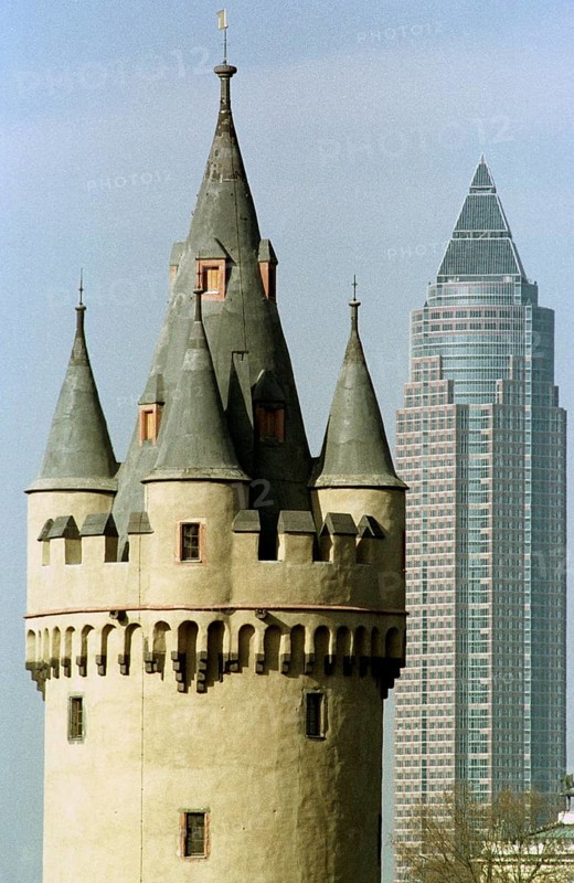Frankfurt/Main, DEU, 01.07.1994 -- Visual comparison between the Bockenheimer Warte tower and the Frankfurt Messeturm. -- The old Bockenheim tower, left, with Frankfurt's fair tower right in the background.