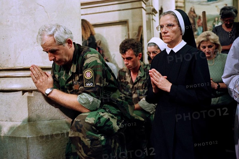 BIH, Sarajevo, 01.09.1995 -- A Bosnian soldier prays together with a Catholic nun during a service in Sarajevo. -- Bosnian soldiers and a catholic now pray during a Sunday mess in Sarajevo.   Bosnia Hercogovina, Eastern Europe