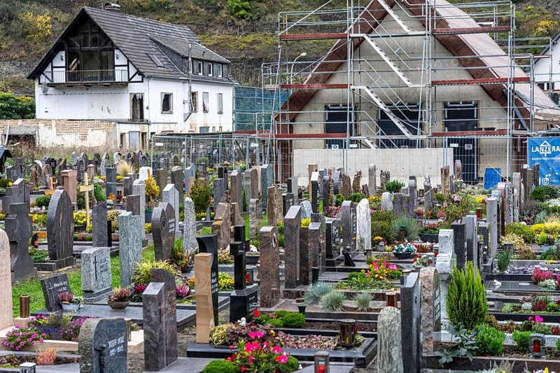 Reconstruction in the Ahr Valley, after the flood of July 2021, buildings that have not yet been renovated or demolished can be found in many places, but most buildings have now been repaired or rebuilt, restored cemetery, new cemetery hall under construction, near Altenahr, Rhineland-Palatinate
