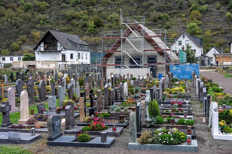 Reconstruction in the Ahr Valley, after the flood of July 2021, buildings that have not yet been renovated or demolished can be found in many places, but most buildings have now been repaired or rebuilt, restored cemetery, new cemetery hall under construction, near Altenahr, Rhineland-Palatinate