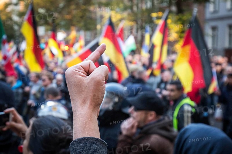DEU Germany Germany Berlin Right demonstration 'We for Germany' passes through Berlin-Mitte. A counter demonstrator shows the middle finger