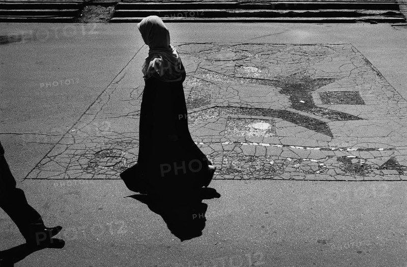 BIH, Bosnia, Sarajevo, 22.07.2005, People walk past the Olympic emblem of the 1984 Winter Games