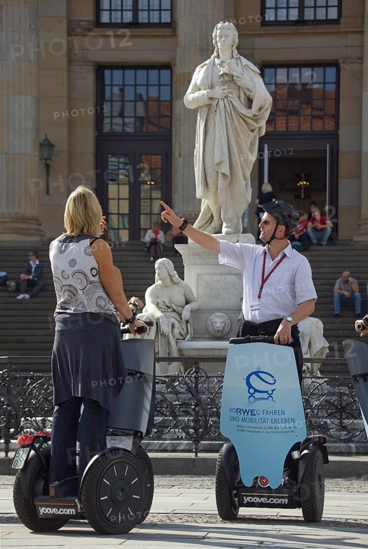 GERMANY Berlin Segway drivers during a guided city tour in front of the Schiller Monument on the Gendarmenmarkt. Germany Berlin Segway driver during a visit to the Gendarmenmarkt in front of a statue of German author Schiller