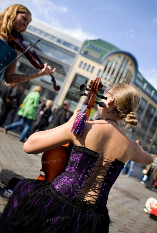 GERMANY Berlin Street musicians in corsets play violin and cello at Hackescher Markt. Germany Berlin Street musicians playing violin and cello at a famous spot Hackescher Markt