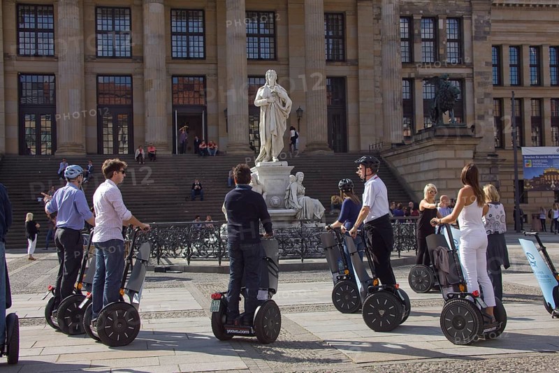 GERMANY Berlin Segway drivers during a guided city tour in front of the Schiller Monument on the Gendarmenmarkt. Germany Berlin Segway driver during a visit to the Gendarmenmarkt in front of a statue of German author Schiller
