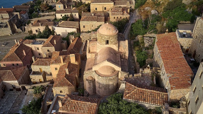 Drone view, aerial view of a compact church structure with domed roof, surrounded by traditional houses, Monemvasia, Monemvassia, Malvasy, Byzantine small town, rocky island, fortress, Laconia, Peloponnese, peninsula, Greece