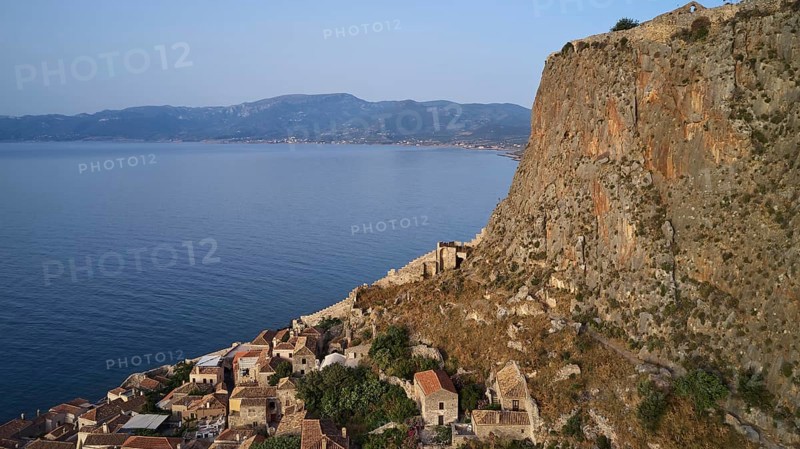 Drone shot, coastal landscape with cliffs, traditional village and mountain view, Monemvasia, Monemvassia, Malvasy, Byzantine small town, rocky island, fortress, Laconia, Peloponnese, peninsula, Greece