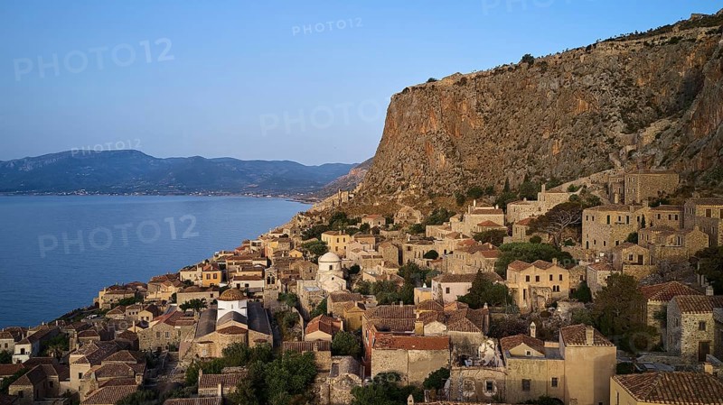 Drone shot, steep cliff with traditional village architecture and sea view, Monemvasia, Monemvassia, Malvasy, small Byzantine town, rocky island, fortress, Laconia, Peloponnese, peninsula, Greece