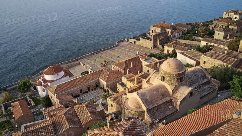 Drone shot, Holy Church of the Virgin Mary Chrysaphitissa, historic town with tiled roofs and church situated by the sea, Monemvasia, Monemvassia, Malvasy, Byzantine small town, rocky island, fortress, Laconia, Peloponnese, peninsula, Greece