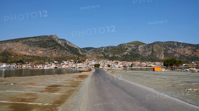 Paved road leads to a seaside town with mountains in the background, Monemvasia, Monemvassia, Malvasy, Byzantine small town, rocky island, fortress, Laconia, Peloponnese, peninsula, Greece