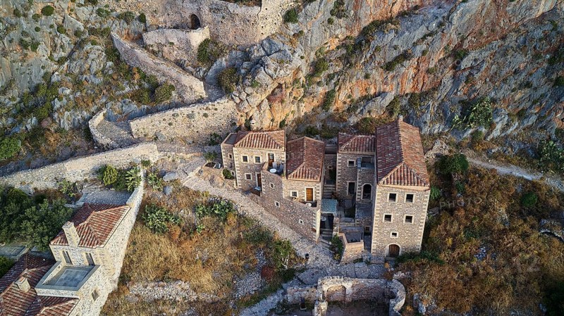 Drone view, aerial view of an ancient fortress with stone houses and vegetation on rocky terrain, Monemvasia, Monemvassia, Malvasy, small Byzantine town, rocky island, fortress, Laconia, Peloponnese, peninsula, Greece