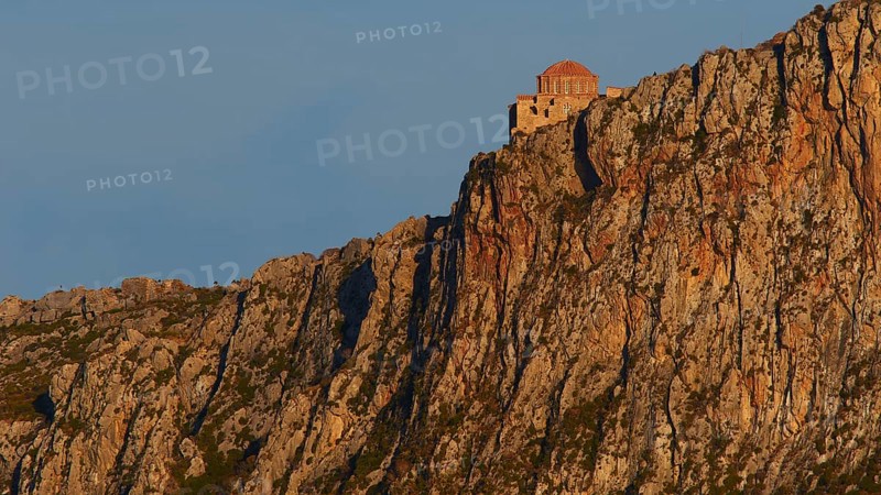 Orhodox church of Hagia Sophia, secluded monastery buildings on rough rocks, illuminated by the evening sun, Monemvassia, Malvasy, small Byzantine town, rocky island, fortress, Laconia, Peloponnese, peninsula, Greece