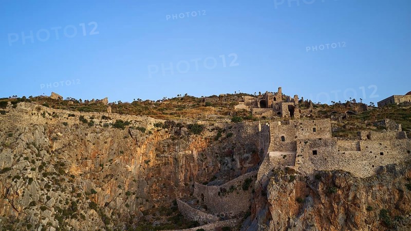 Drone shot, Old rock castle rising above the coastal landscape, Monemvasia, Monemvassia, Malvasy, Byzantine small town, rocky island, fortress, Laconia, Peloponnese, peninsula, Greece