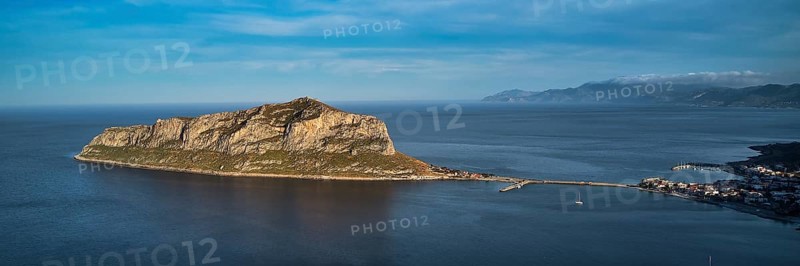 Drone shot, island connected to the mainland by bridge, surrounded by blue water, Monemvasia, Monemvassia, Malvasy, small Byzantine town, rocky island, fortress, Laconia, Peloponnese, peninsula, Greece