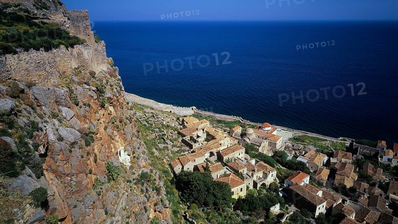 Coastal panorama with villages and cliffs falling down to the vast blue sea, Monemvasia, Monemvassia, Malvasy, small Byzantine town, rocky island, fortress, Laconia, Peloponnese, peninsula, Greece