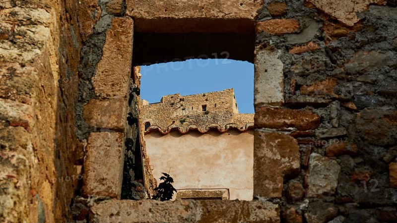 Soft morning light, view through an old window of a ruin with clear blue sky, Monemvasia, Monemvassia, Malvasy, Byzantine small town, rocky island, fortress, Laconia, Peloponnese, peninsula, Greece