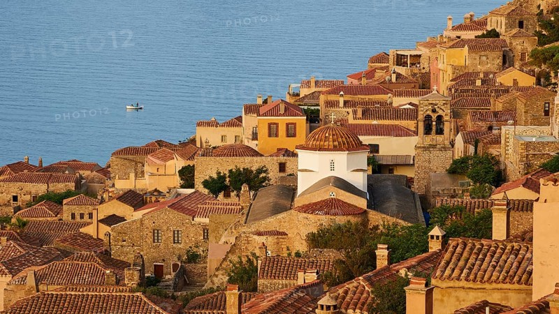Soft morning light, Holy Church of the Virgin Mary Myrtidiotissa (or Critikias), church tower and historic buildings on the coast with panoramic views and warm light, Monemvassia, Malvasy, small Byzantine town, rocky island, fortress, Laconia, Peloponnese, peninsula, Greece