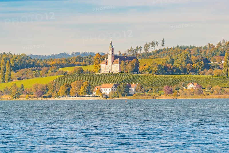 A church on a hill above autumn vineyards and a lake, surrounded by picturesque landscapes and trees, Birnau, Lake Constance, Germany