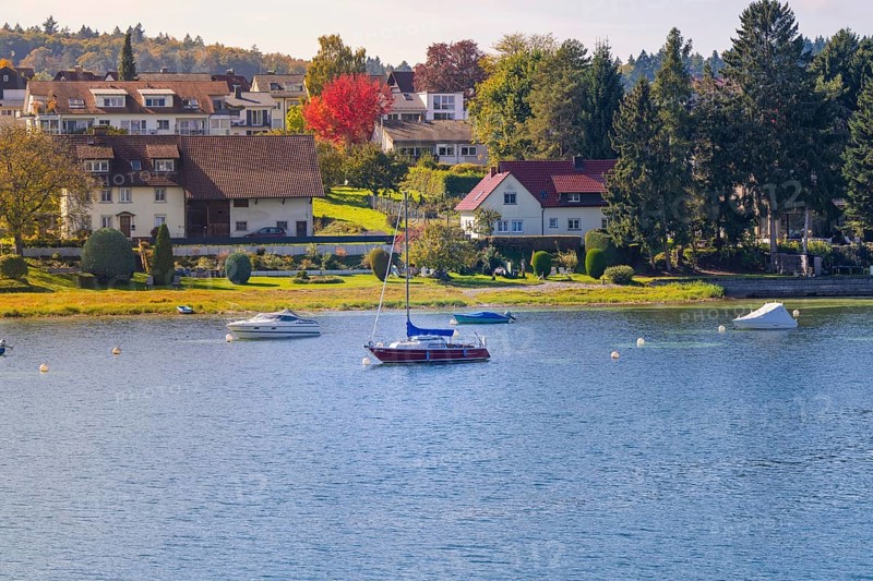 Seascape with colorful shore and various boats, boat trip, Lake Constance, Germany