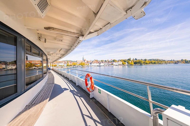 View from the ferry of a coastal town with clear sky, boat trip, Lake Constance, Germany