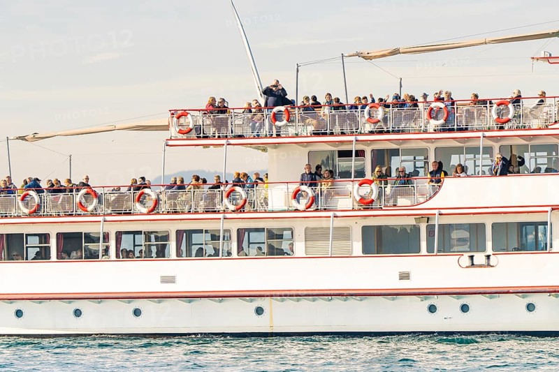 Passenger ship full of people on a lake, all enjoying the sunny day, boat trip, Lake Constance, Germany