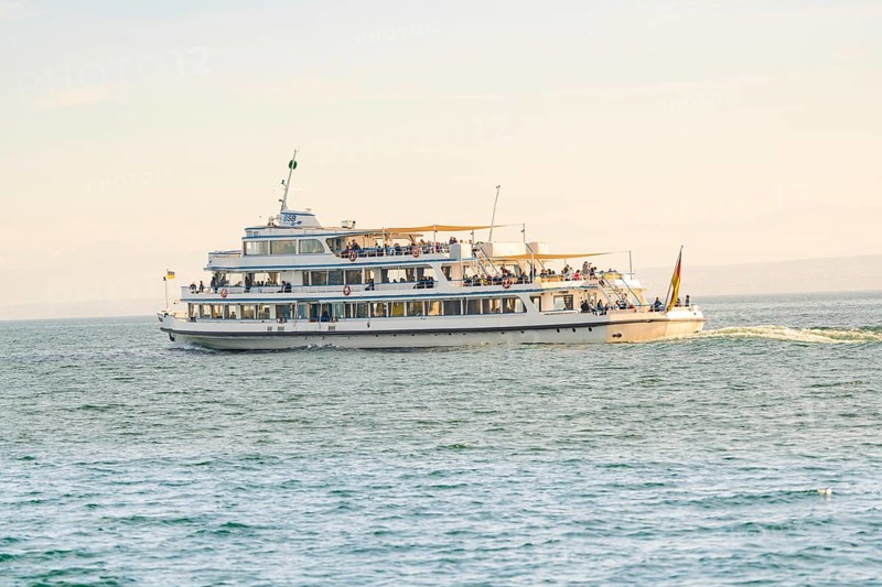 Large passenger ship full of people on calm water under a sunny sky, boat trip, Lake Constance, Germany