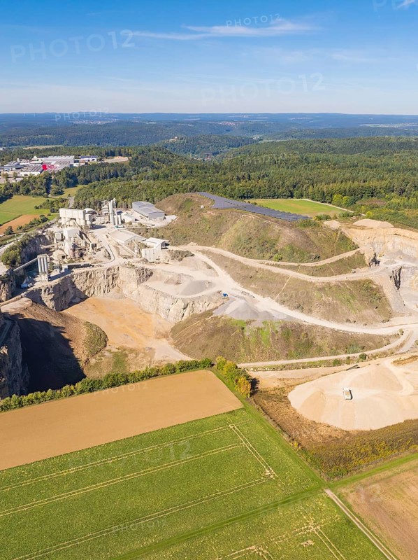 A quarry in a green landscape with forest and cultivated fields, Nagold, Black Forest, Germany