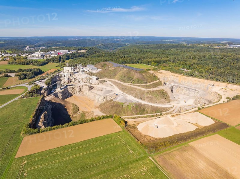 View of a large quarry with surrounding fields and forests, Nagold, Black Forest, Germany