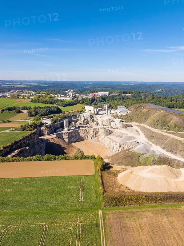 A spacious aerial view of a quarry surrounded by fields and forests, Nagold, Black Forest, Germany