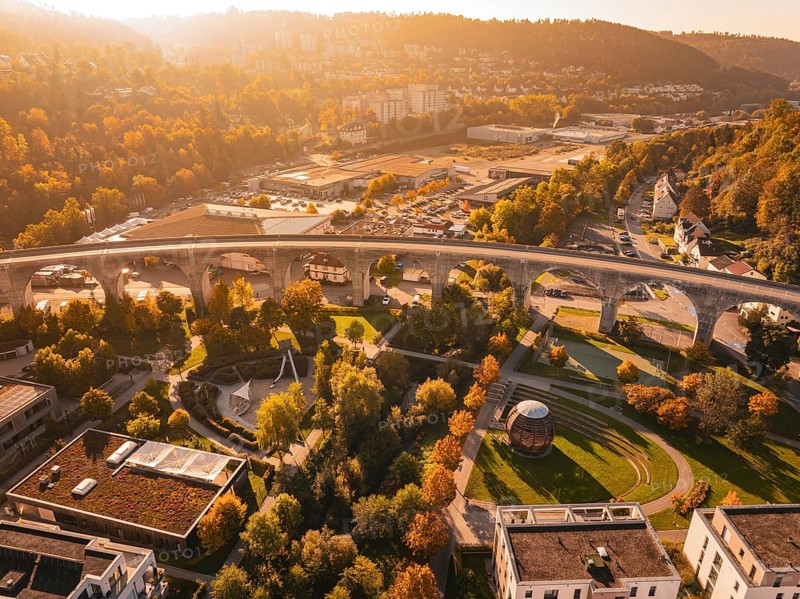 A viaduct in an autumn urban landscape, surrounded by buildings and parks, Nagold, Black Forest, Germany