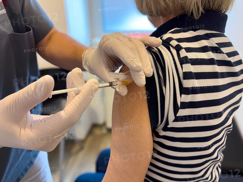 Patient woman receives injection in upper arm for vaccination against contagious disease flu flu vaccination flu protection against influenza virus influenza infections, corona corona vaccination corona protection corona protection coronavirus protection coronavirus, international