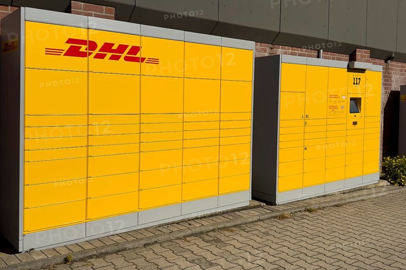 Large DHL packing station in typical yellow color with red logo, Germany