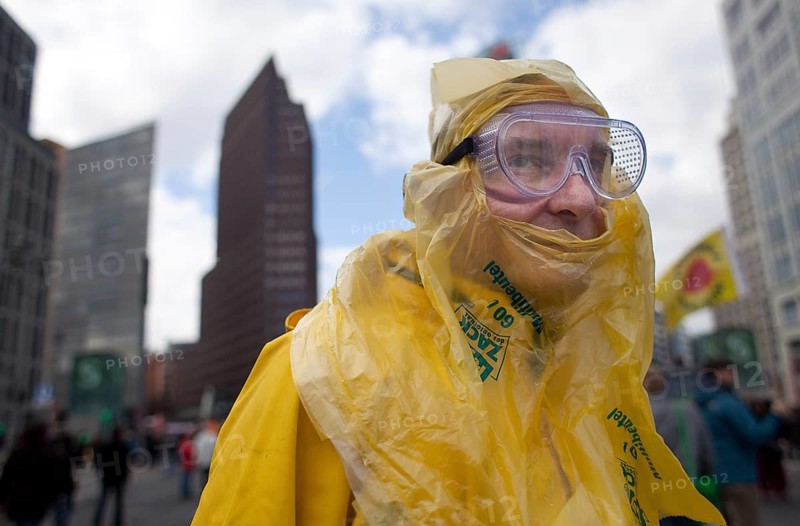 Germany Berlin Anti-nuclear power demonstration in Berlin Mitte. A demonstrator wearing a symbolic protective suit Germany Berlin Protest Rally against Nuclear Power Plants. A Protester Dressed in a Symbolic Protection Coat