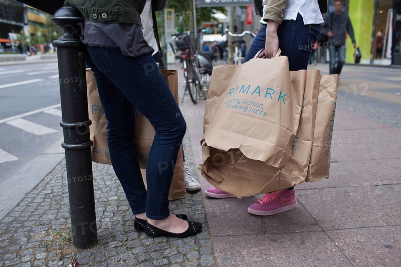 DEU Germany Germany Berlin Young girl with opened Primark shopping bag on Kurfürstendamm in Berlin