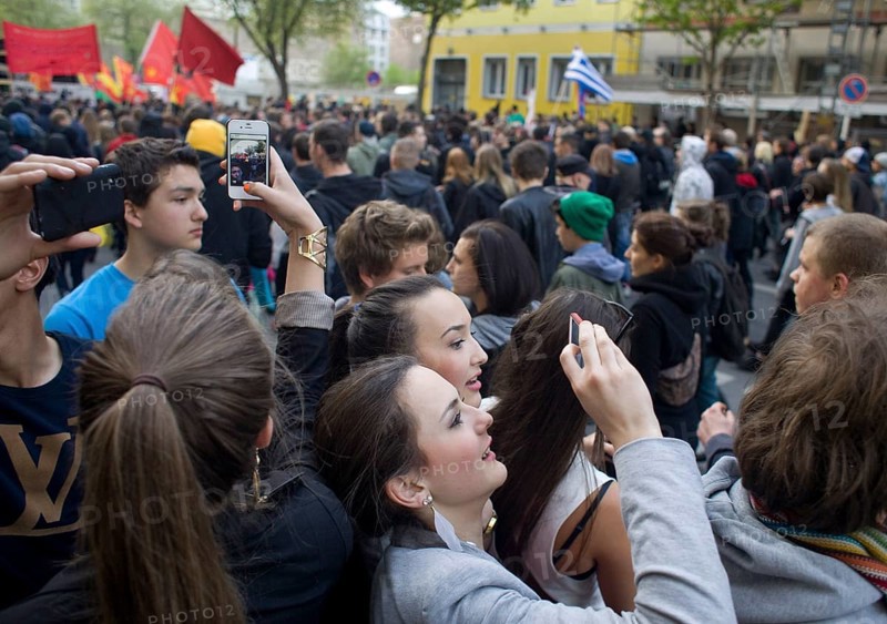 GERMANY Tourists are filming the May 1st rally on Köpenicker Straße. Germany Berlin Tourists Covering the May Day Protest in Front of Their Hostel