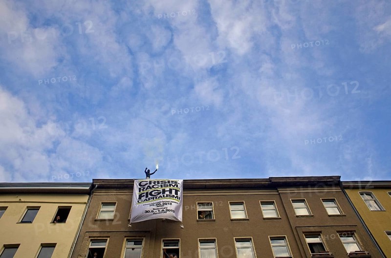 GERMANY Demonstrator with Bengali fire at the May 1 rally in Kreuzberg. Germany Berlin Protester on the roof of a house during the May Day Protest