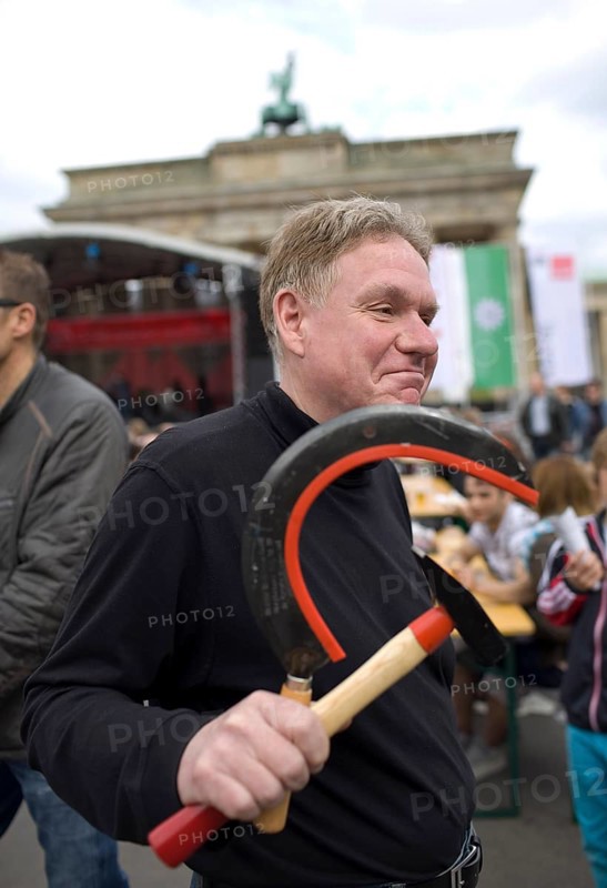 GERMANY A man carries a hammer and sickle in his hand at the DGB rally on May 1. Germany Berlin A man carrries hammer and sicle during the May Day Protest.of the German Unions