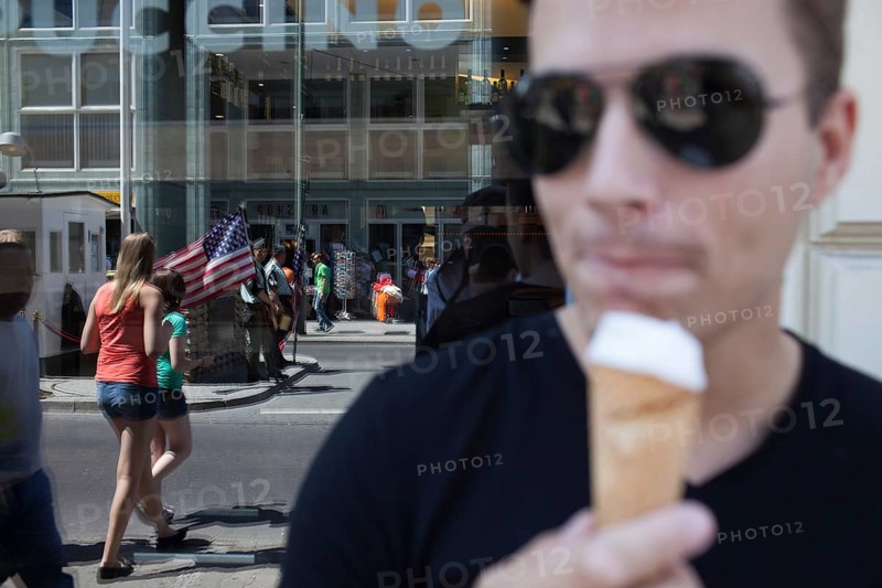 DEU Germany Germany Berlin tourist with ice cream at Checkpoint Charlie