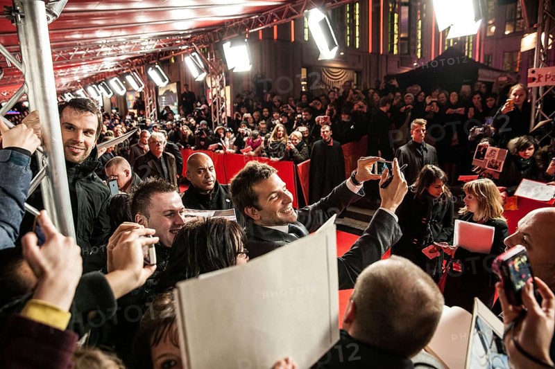 DEU Germany Germany Berlin 64th Berlinale, the international film festival in the German capital. Film premiere in Friedrichsstadtpalast with Bradley Cooper taking pictures of himself with a fan's smartphone