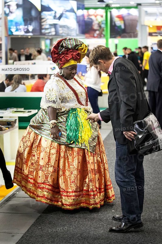 DEU Germany Germany Berlin International Tourism Exchange ITB. A visitor looks at the traditional costume of a Brazilian woman