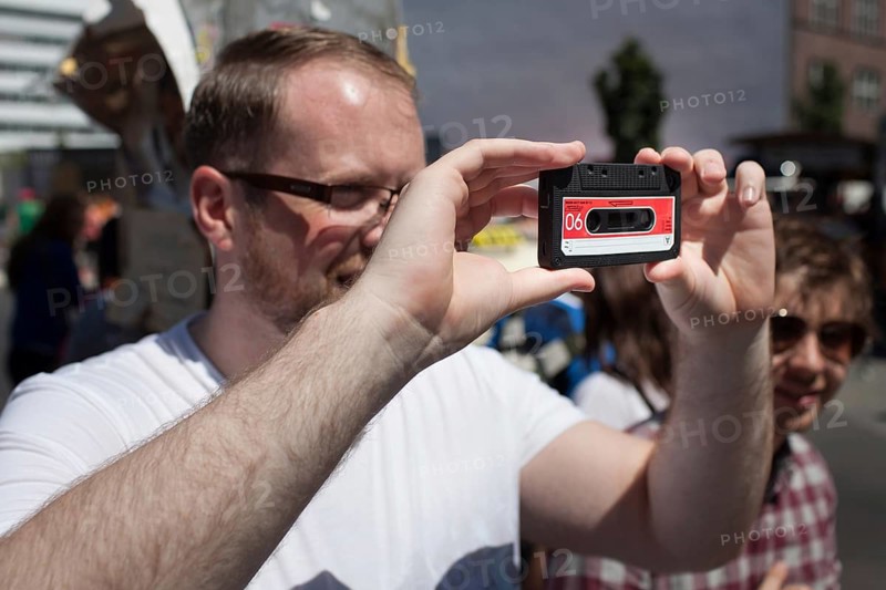 DEU Germany Germany Berlin tourist takes pictures with dummy cassette tape at Checkpoint Charlie