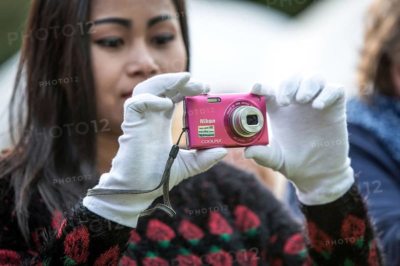 DEU Germany Germany Berlin HZB summer party at the Wannsee site. Woman wearing white gloves taking pictures with a digital viewfinder camera