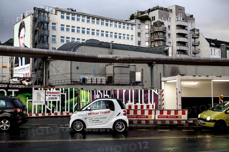 DEU Germany Germany Berlin A smart with the inscription 'economic miracle' in front of a construction site at the memorial church