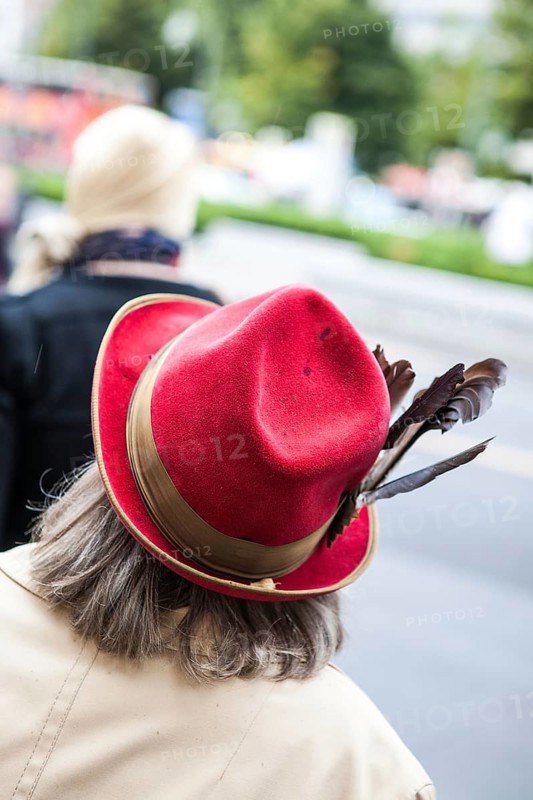DEU Germany Germany Berlin Woman wearing red hat decorated with feathers