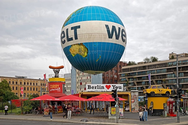 HiFlyer world balloon with the Berlin Loves You gift shop, Curry at the Wall snack bar and the Trabi sculpture, Zimmerstraße, Berlin, Germany