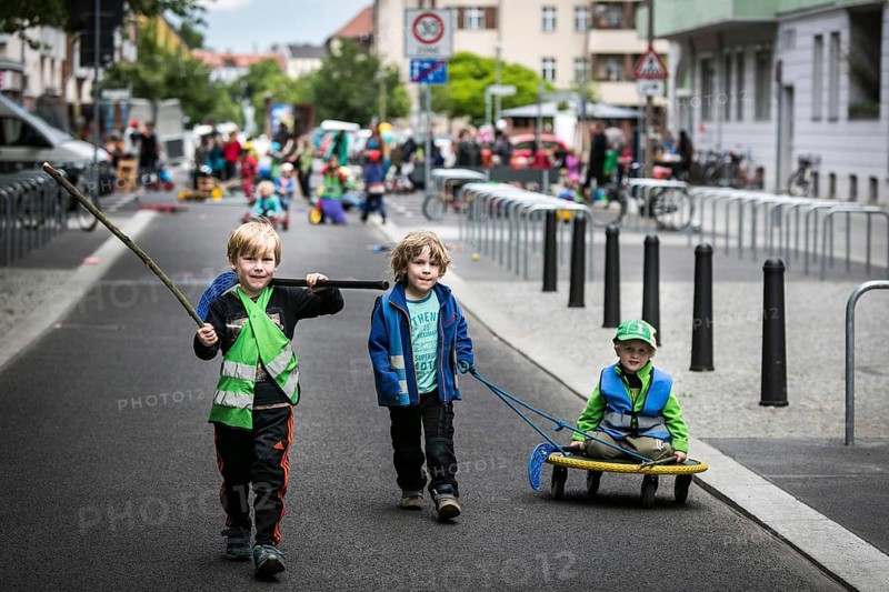 DEU Germany Germany Berlin Children play on Gudvanger Straße, which has been declared the city's first temporary play street. Parents, daycare and a school had worked to temporarily close the road on Oberen Prenzlauer Berg to road traffic