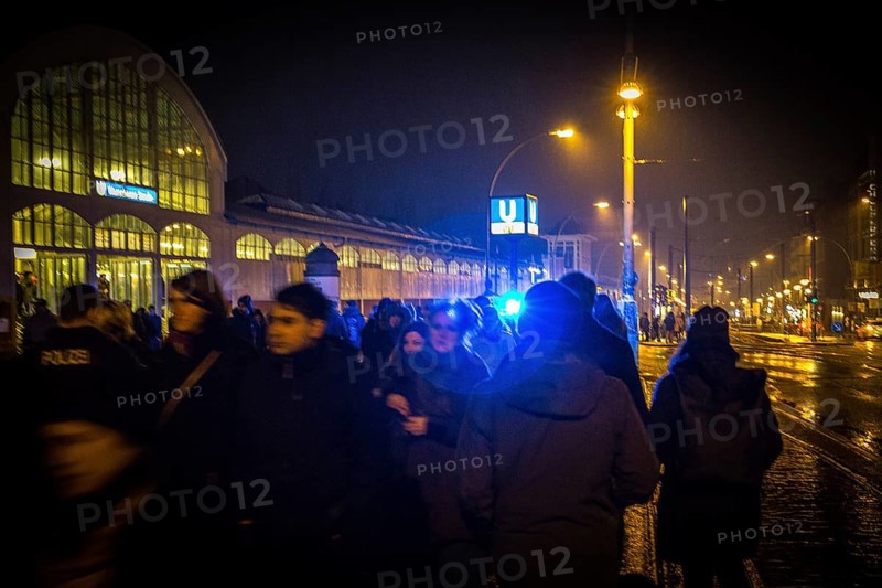 DEU Germany Germany Berlin Scene on the Warsaw Bridge in Berlin-Friedrichshain.People against a blue light from a police patrol at the Warschauer Straße subway station