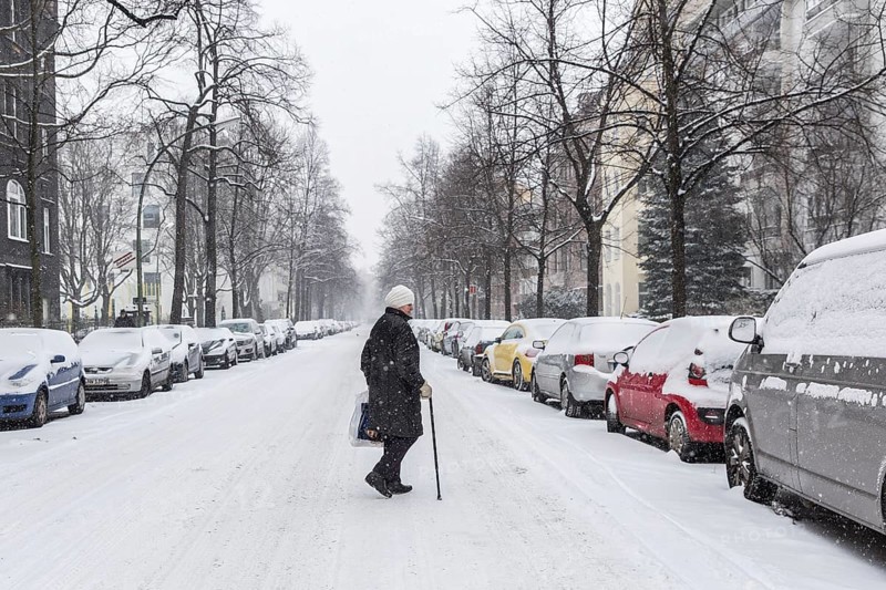 DEU Germany Germany Berlin Walking on snow-covered road in Schöneberg